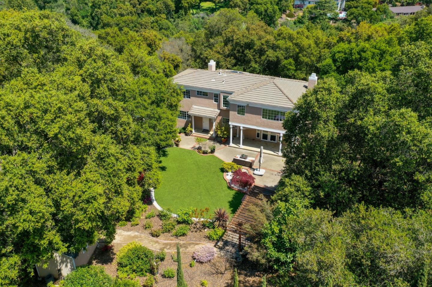Saratoga home aerial view with immaculate lawn surrounded by trees